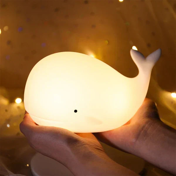 Touch control whale night light, a soothing color-changing LED lamp for children's bedtime comfort.