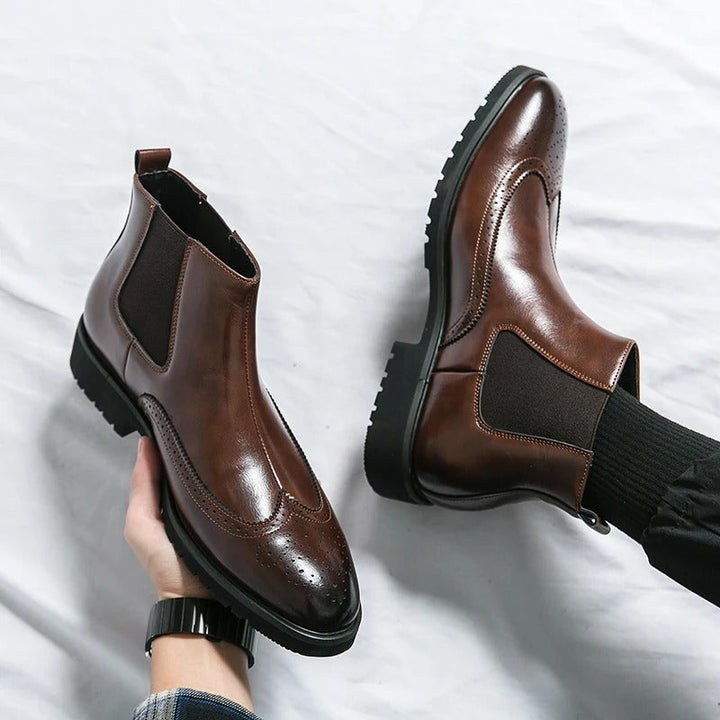 Modern men's sleek slip-on boots, blending traditional brogue with contemporary chelsea design.