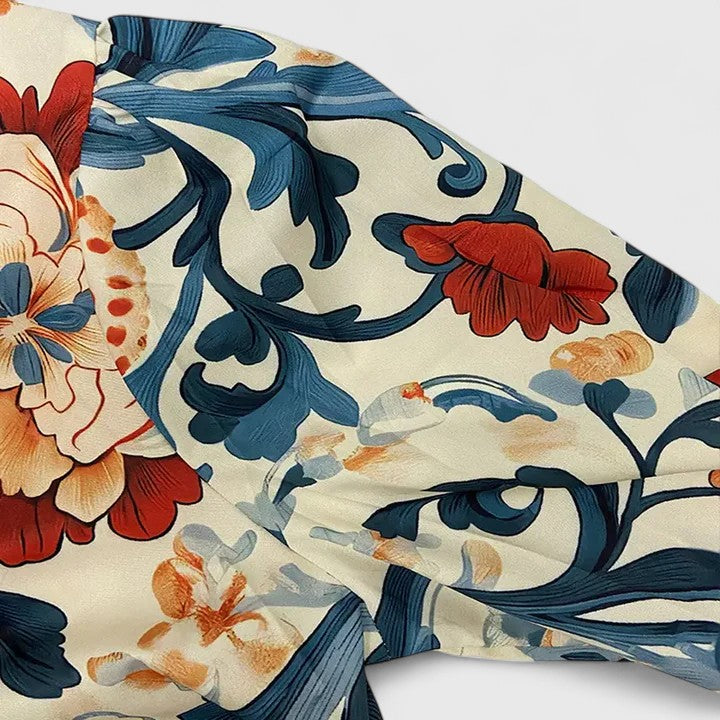 Chic women's dark blue floral blouse. Versatile and elegant top, ideal for stylish everyday wear or special events.