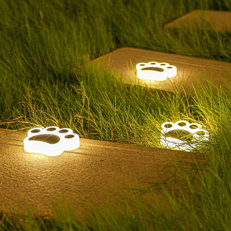 Close-up of a paw print solar light showcasing its detailed design and bright LED illumination