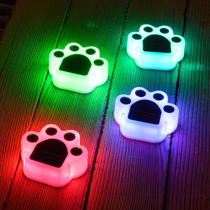 Set of paw print solar lights illuminating a garden path, providing charming and practical outdoor decor