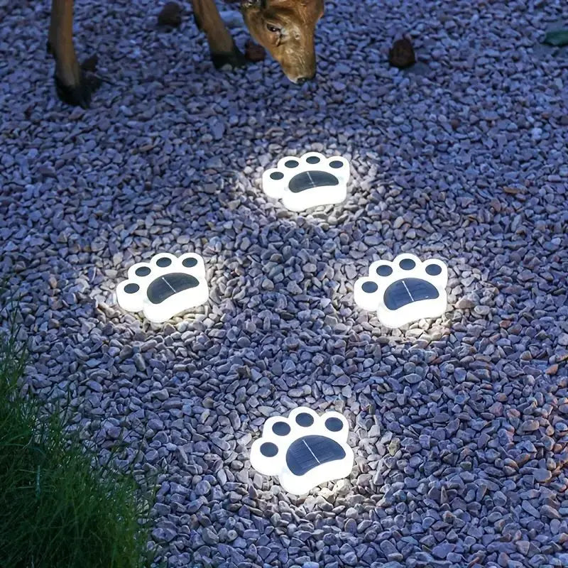 Solar-powered paw print stake lights, casting a warm glow, best for garden parties and pet-friendly yards