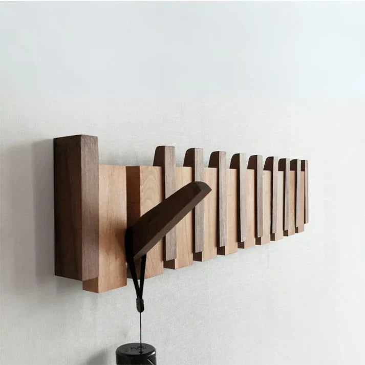 Decorative piano style coat rack, wall mounted entryway organizer with multiple hooks.