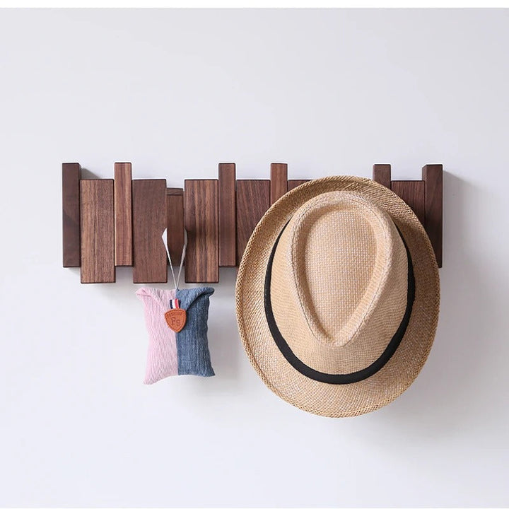 Space-saving wall mounted piano coat rack, functional entryway storage solution with decorative hooks.
