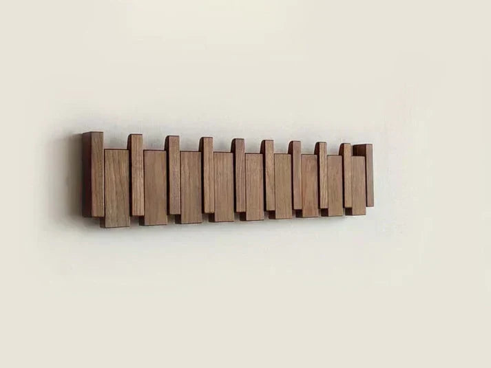 Unique piano key design coat rack, wall mounted solution for stylish entryway storage and decor.