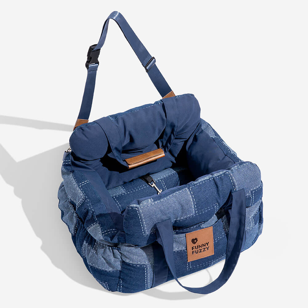 Water-resistant denim dog car seat, comfortable bolster and secure straps for pet travel.