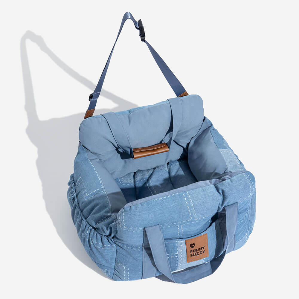 Dog car seat booster in stylish denim, with safety bolster and convenient storage.