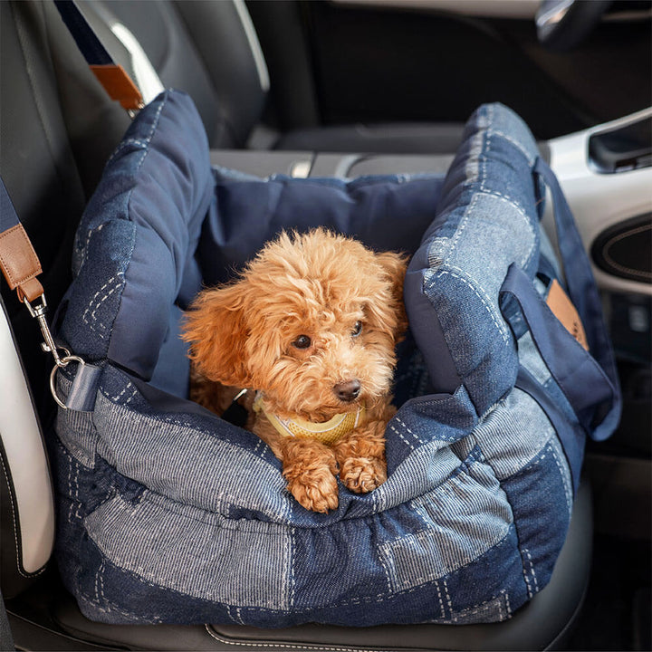 Denim pet travel booster seat with storage pockets, providing comfort and safety for dogs.
