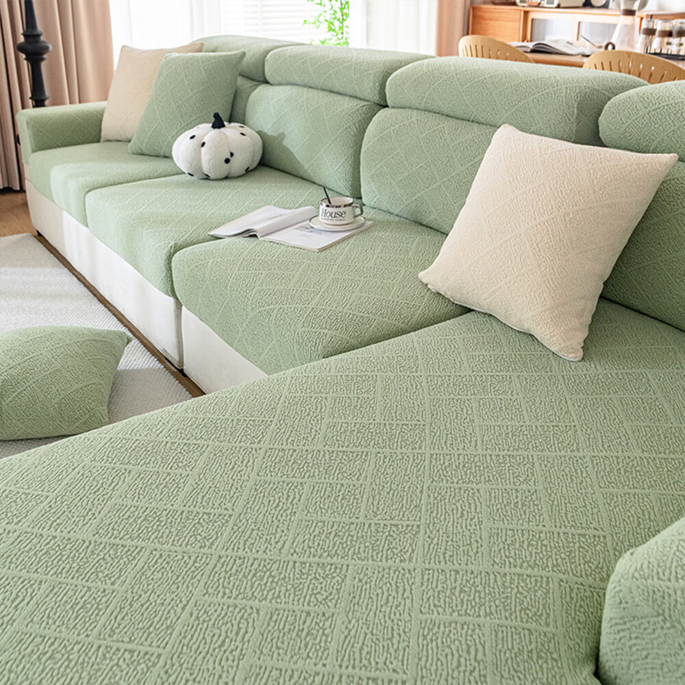 Close-up of diamond jacquard pattern on a plush sofa cover, showing texture and stretch fabric