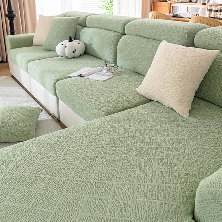 Close-up of diamond jacquard pattern on a plush sofa cover, showing texture and stretch fabric