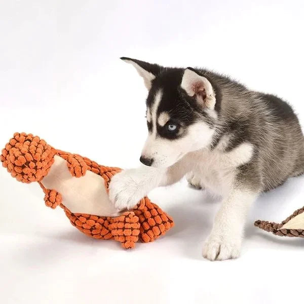 Assortment of green dinosaur plush chew toys for dogs. Durable and eco-friendly pet supplies.
