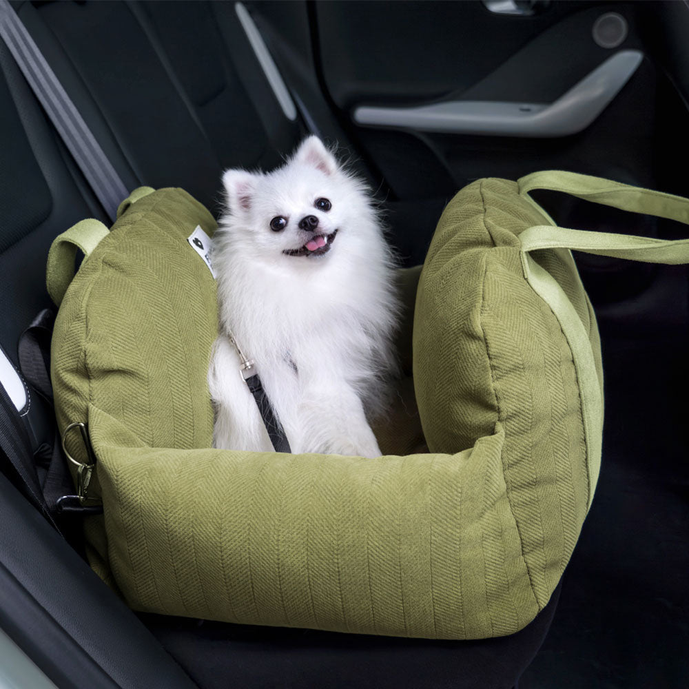 Close-up of herringbone dog car seat fabric, soft bolster, and secure buckles for comfortable travel