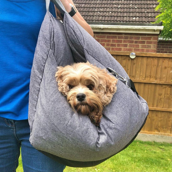 Secure dog car seat for small breeds, integrated leash attachment for safety.