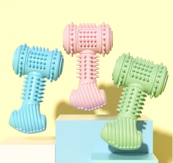 Dog chewing on a blue dumbbell dental toy, promoting teeth cleaning and oral health.