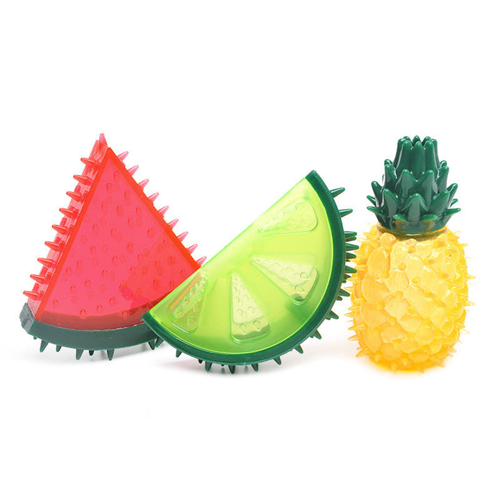 Dog chewing on a blue water-filled frozen fruit dog toy, perfect for teething relief and summer play.