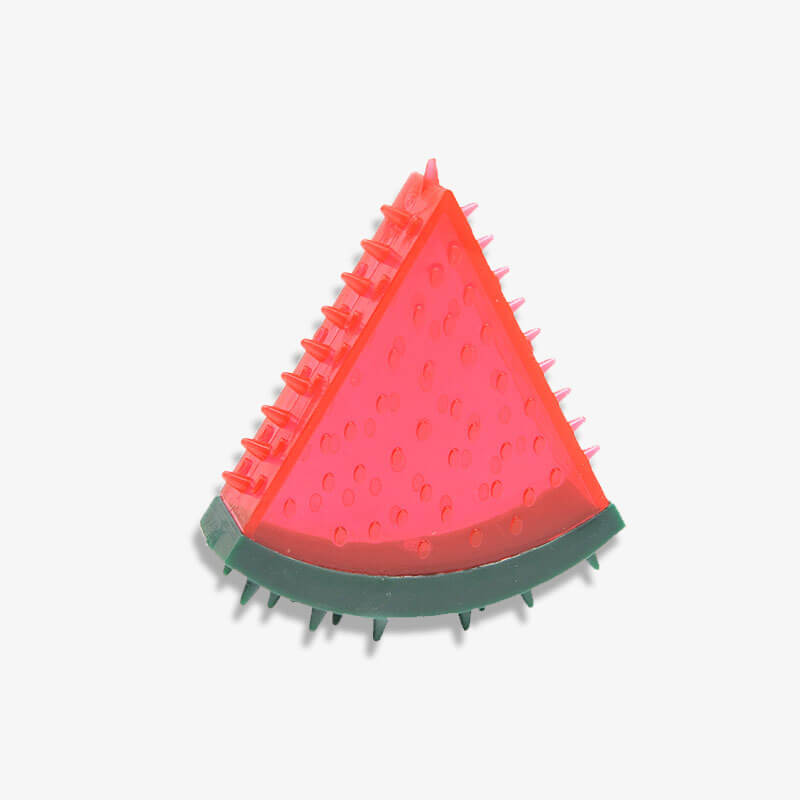 Water droplets visible on a frozen water-filled fruit dog toy, highlighting its cooling feature.