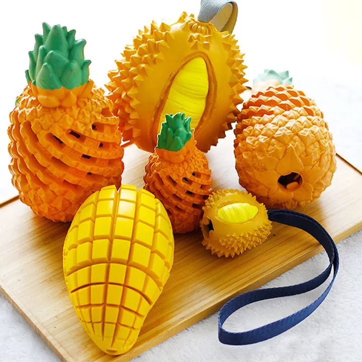 Set of colorful fruit-shaped rubber dog chew toys, including apple, pear, and orange designs.