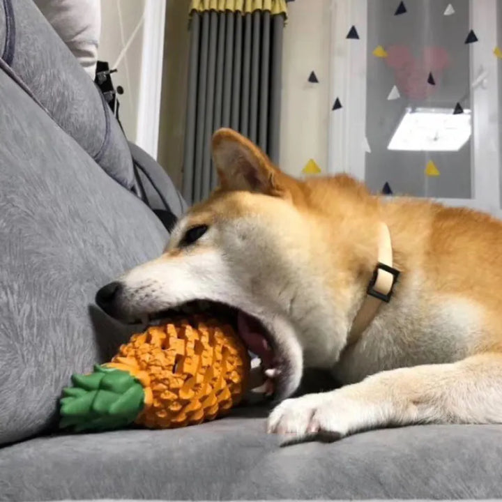 Pink pineapple-shaped rubber dog chew toy, designed for stimulating play and gum massage.