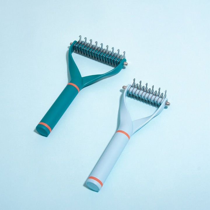 Close-up of a double-sided blade dematting comb, ideal for efficient dog grooming and deshedding.