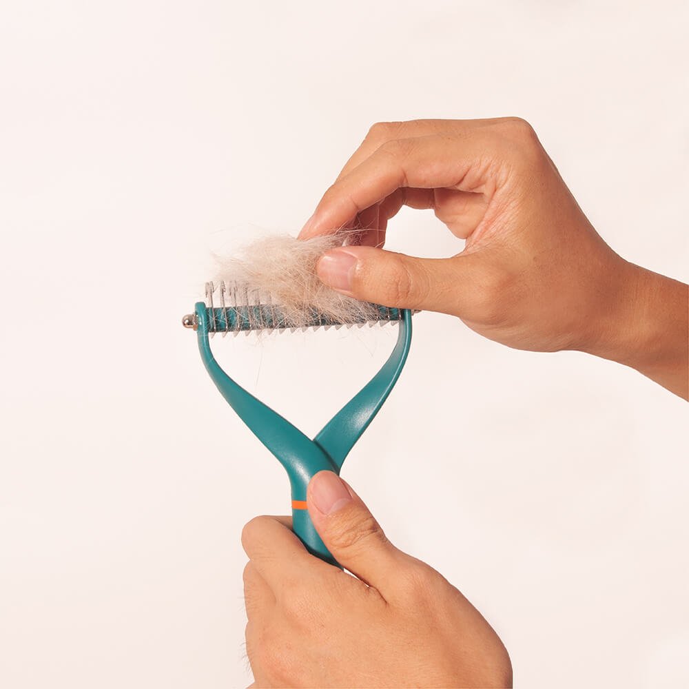 Dog grooming tool: double-sided dematting comb for effective hair removal and pet deshedding.