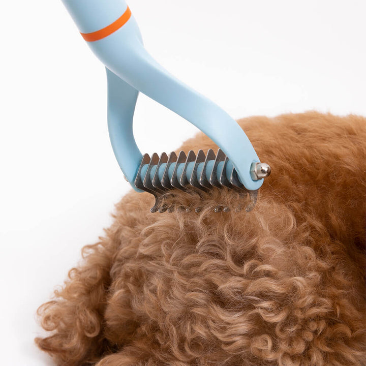 Ergonomic dematting comb designed for comfortable dog grooming, tackling tangles and shedding.