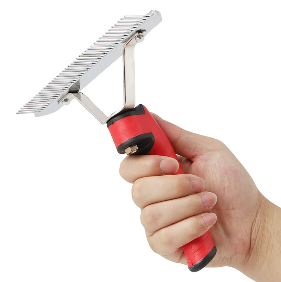 Close up of dematting rake blades and red handle, for large breed dog grooming and pet care