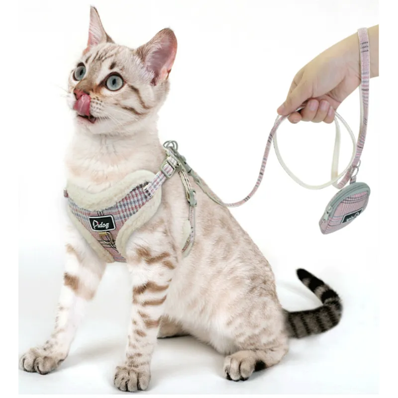 Stylish black and white checked dog harness, designed for comfort, paired with a durable leash and a waste bag holder.