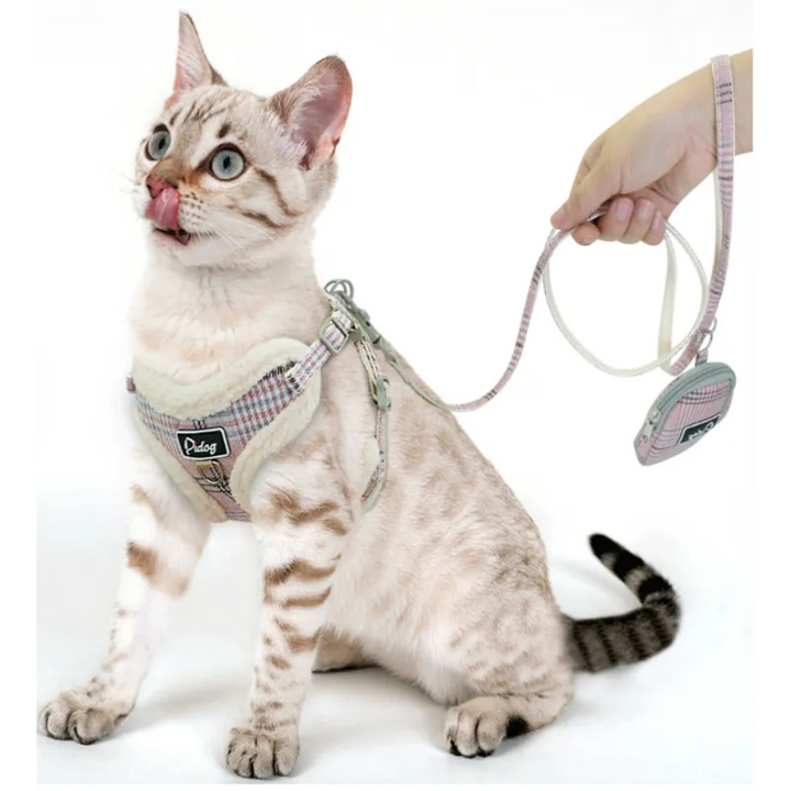 Stylish black and white checked dog harness, designed for comfort, paired with a durable leash and a waste bag holder.