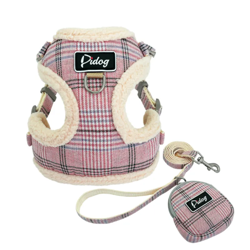 Durable dog harness and leash in checked print, includes waste bag dispenser, ensuring comfortable and clean dog walks.