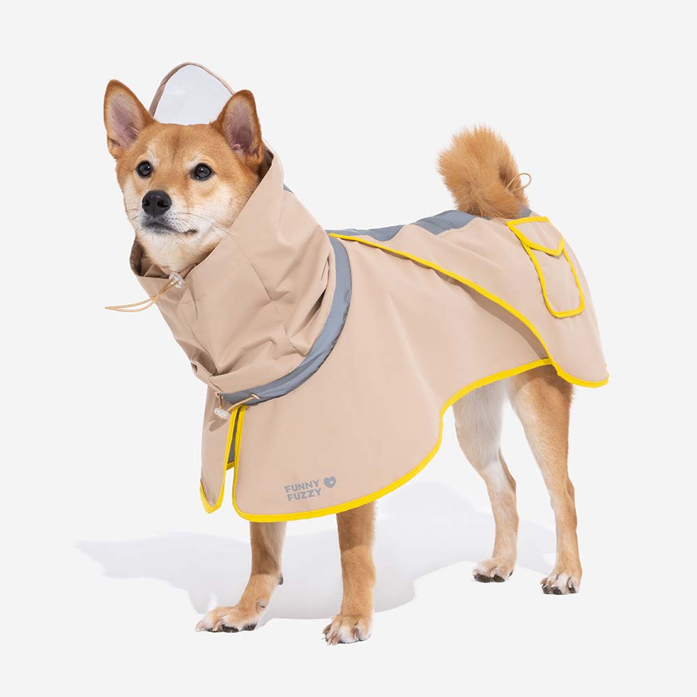 Father and child with their dog, all wearing matching green waterproof raincoats, smiling, family outdoor fun
