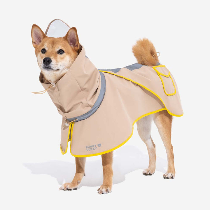 Father and child with their dog, all wearing matching green waterproof raincoats, smiling, family outdoor fun