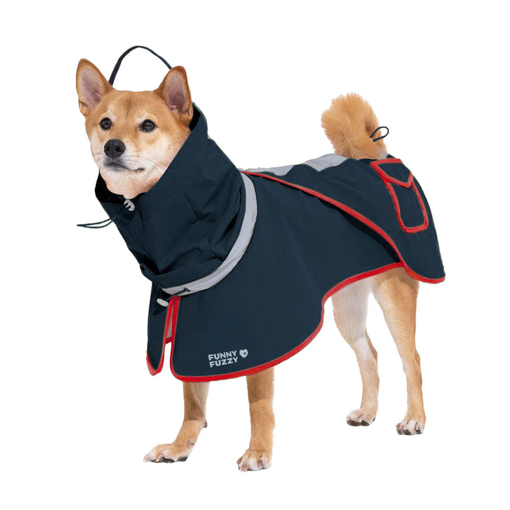 Dog wearing an adjustable, reflective blue waterproof raincoat, sitting patiently in a muddy park, pet gear
