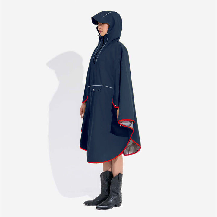 Back view of a human in a matching red waterproof raincoat, with reflective accents, walking their dog