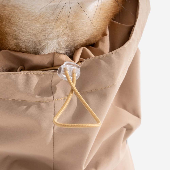 Flat lay of a red dog raincoat and human jacket, showing waterproof fabric and reflective accents, matching set