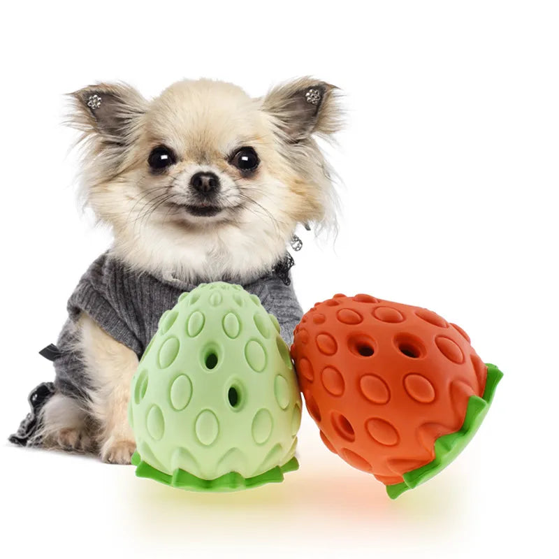 Close-up of red strawberry-shaped rubber chew toy for dogs, pet supplies