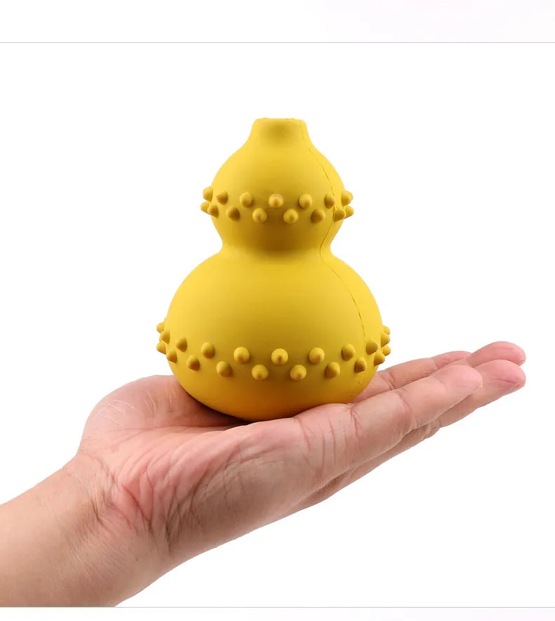 Happy dog engaged with a treat-dispensing chew toy, promoting slow feeding.