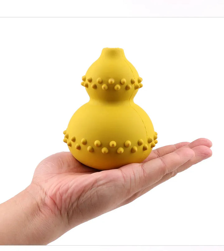 Happy dog engaged with a treat-dispensing chew toy, promoting slow feeding.