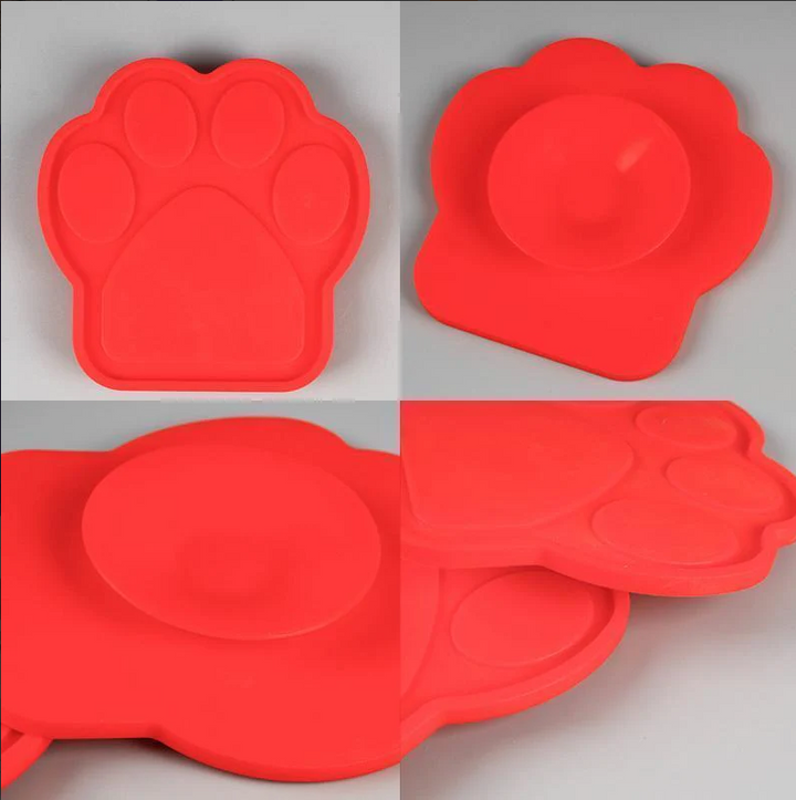 Dog lick mat suctioned to a bathtub, used for calming and anxiety relief during pet baths