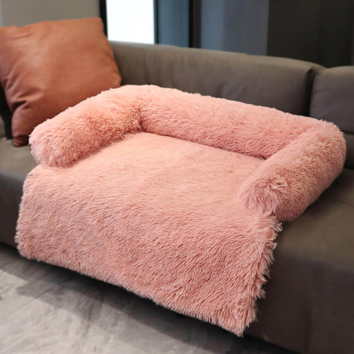 Dog sleeping soundly on a plush furniture protector with a fuzzy backrest, ultimate pet comfort
