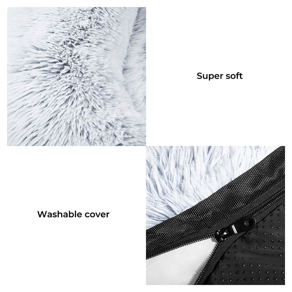 Stylish pet accessory: calming dog bed and couch cover with textured fuzzy backrest on a clean sofa