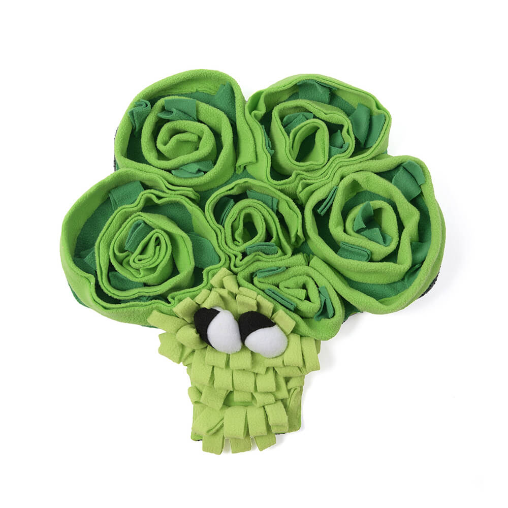 Happy dog playing with a green and orange vegetable snuffle mat dogtoy