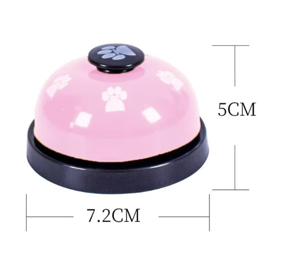 Close-up of a dog training bell on a wooden floor, pet accessory for communication