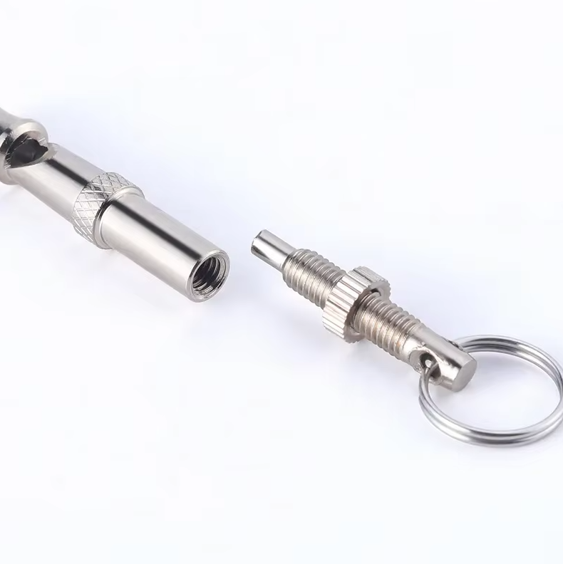Close-up of a dog training whistle, essential pet care tool for effective command practice.