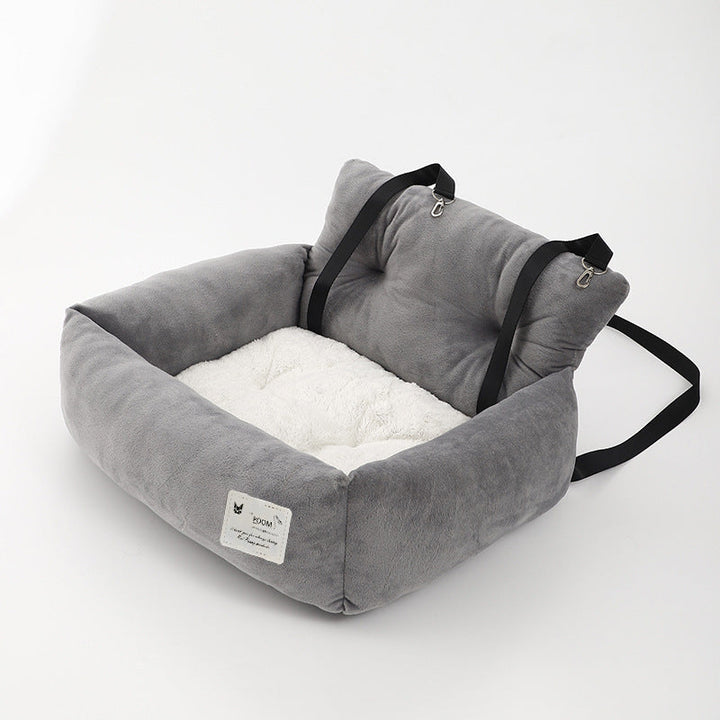 Pet car booster seat with adjustable straps, ensuring dog safety and car protection during travel.