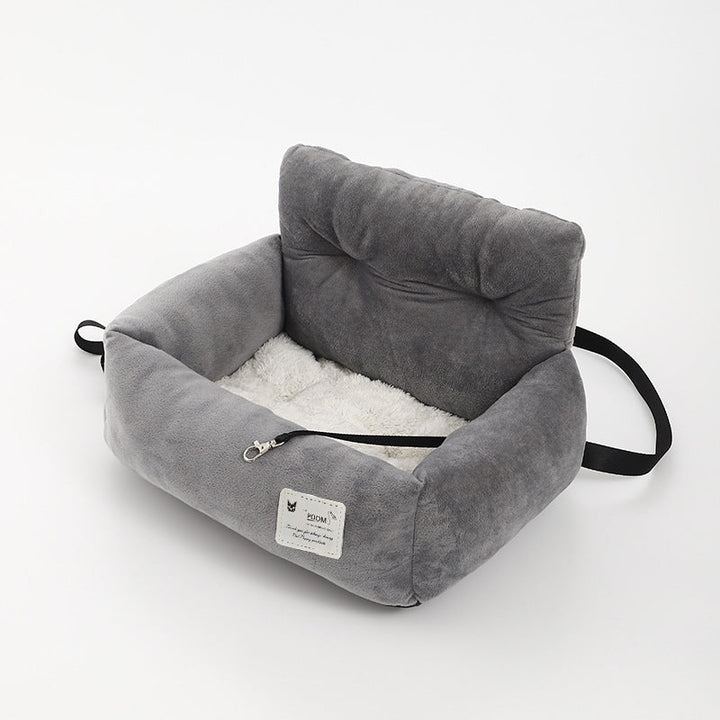 Comfortable dog car seat for safe pet travel, featuring a washable cover and secure attachment.