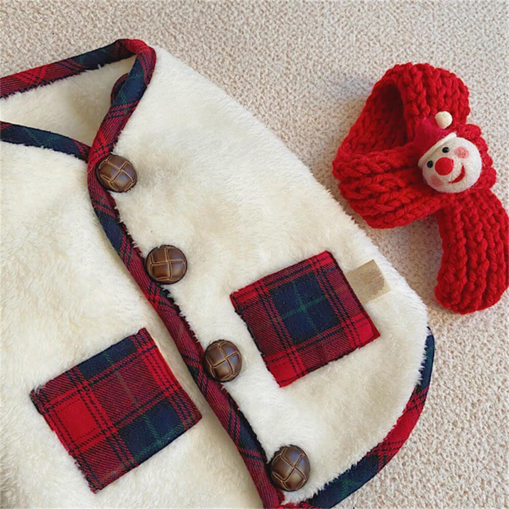 Close-up of dog's back wearing a red plaid winter jacket with scarf, holiday pet fashion