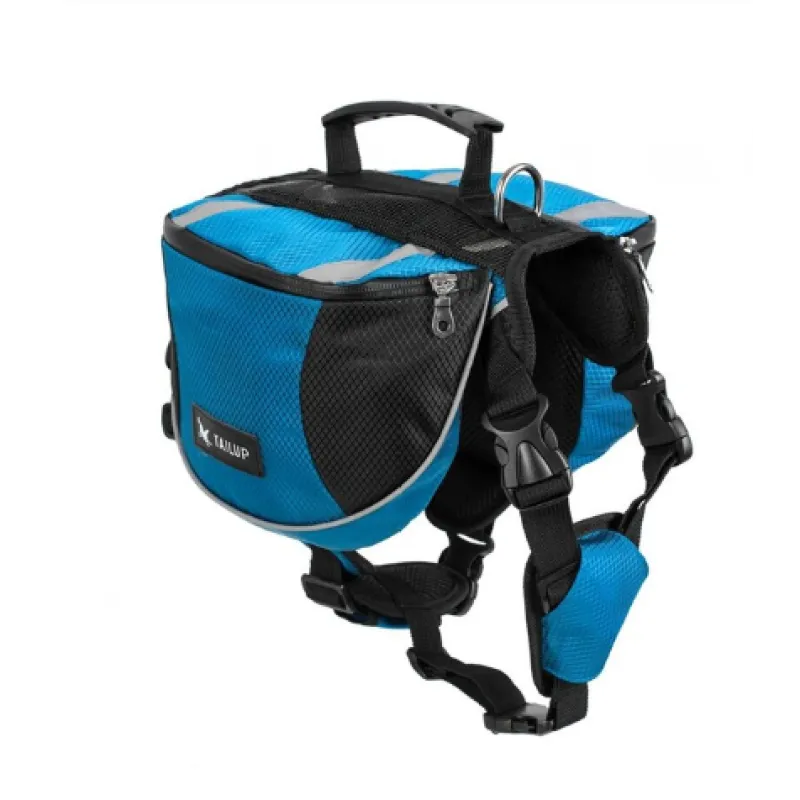 Dog wearing a blue waterproof outdoor adventure backpack, looking ahead on a mountain trail, pet accessory.