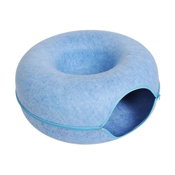 Donut-shaped cat bed in a neutral tone, adaptable as a cozy cave; modern pet furniture