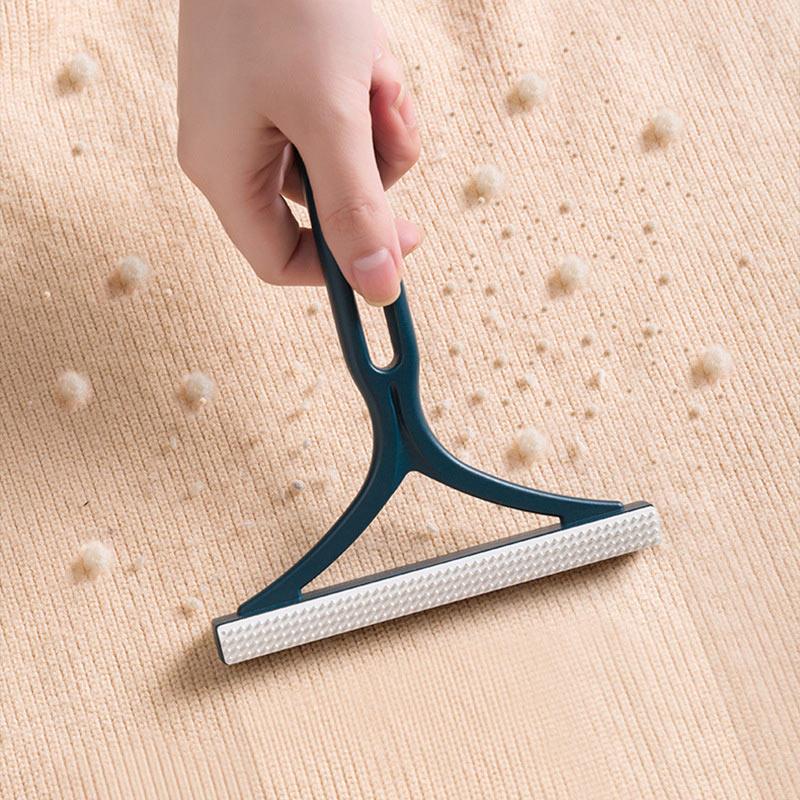 Compact pet hair remover with two sides, ideal for lint and fur on furniture and clothing.