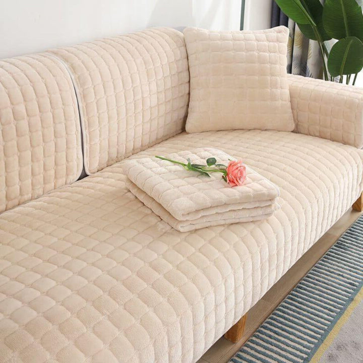 Cream square flannel sofa cover with anti-slip backing. Quilted, scratch-resistant couch protector for pets.